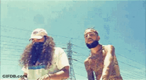 Two Men Are Standing Next To Each Other In Front Of Power Lines GIF