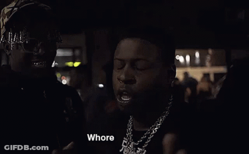 Two Men Are Standing Next To Each Other In The Dark . GIF