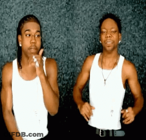 Two Men Are Standing Next To Each Other In White Tank Tops GIF