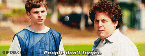 Two Men Are Standing Next To Each Other On A Field And One Of Them Is Saying People Don 'T Forget . GIF