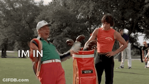 Two Men Are Standing Next To Each Other On A Golf Course . GIF