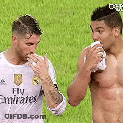 Two Men Are Standing Next To Each Other On A Soccer Field And One Of Them Is Wearing A Fly Emirates Shirt . GIF