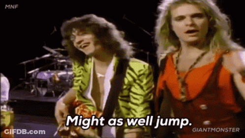 Two Men Are Standing Next To Each Other On A Stage And One Of Them Is Saying `` Might As Well Jump '' . GIF