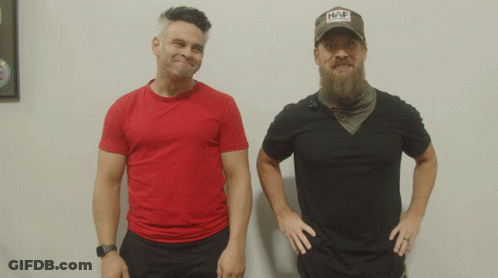 Two Men Are Standing Next To Each Other One Wearing A Hat That Says Hap GIF