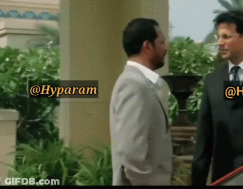 Two Men Are Standing Next To Each Other With A Sign That Says @Hyparam GIF