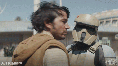 Two Men Standing Next To Star Wars Logo GIF
