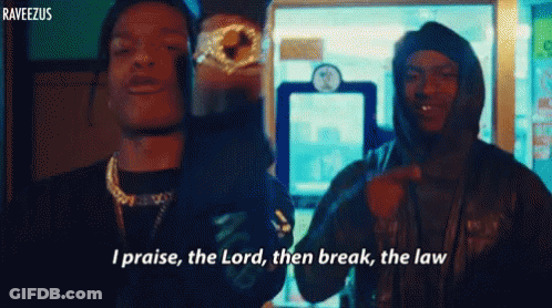 Two Men Are Standing Next To Each Other With One Saying I Praise The Lord Then Break The Law . GIF