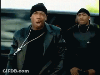Two Men Are Standing Next To Each Other With One Wearing A Beanie And A Leather Jacket GIF