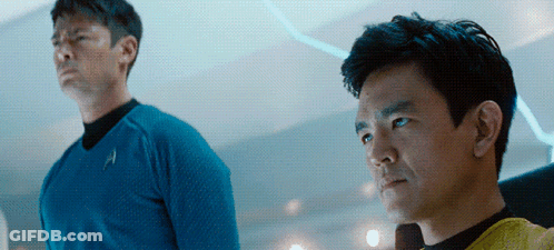 Two Men Are Standing Next To Each Other With One Wearing A Blue Shirt With The Letter A On It GIF