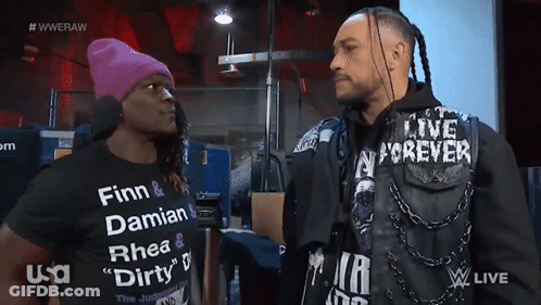 Two Men Are Standing Next To Each Other With One Wearing A Shirt That Says Finn And Damian GIF