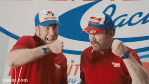 Two Men Are Standing Next To Each Other With One Wearing A Wonder Hat . GIF