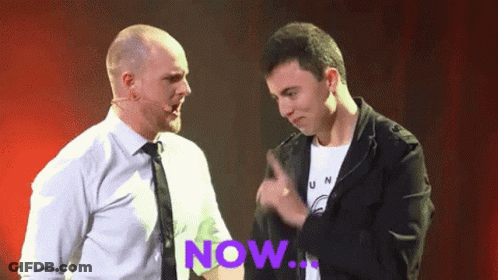 Two Men Are Standing Next To Each Other With The Word Now Written In Purple GIF