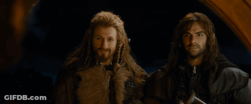 Two Men Are Standing Next To Each Other With The Words At Your Service Written On The Bottom GIF