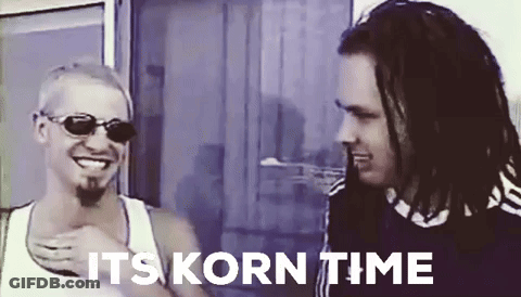 Two Men Are Standing Next To Each Other With The Words " It 'S Korn Time " Written Above Them GIF