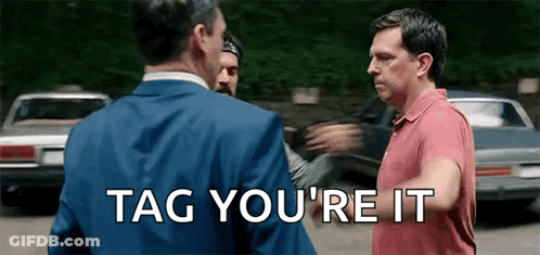 Two Men Are Standing Next To Each Other With The Words Tag You 'Re It On The Bottom GIF