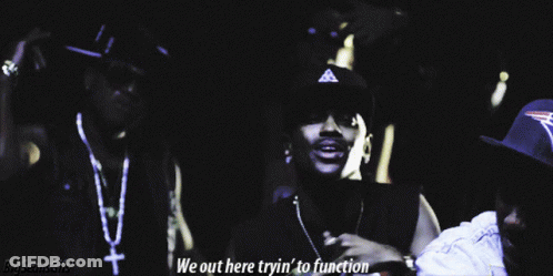 Two Men Are Standing Next To Each Other With The Words We Out Here Tryin ' To Function Below Them GIF