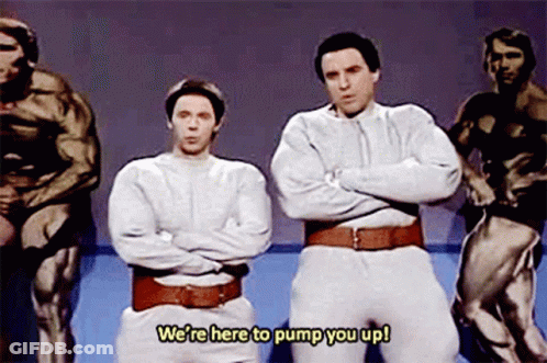 Two Men Are Standing Next To Each Other With Their Arms Crossed And The Words We 'Re Here To Pump You Up Above Them GIF