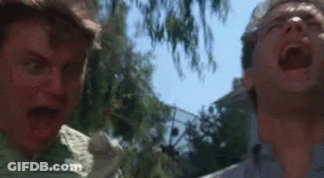 Two Men Are Standing Next To Each Other With Their Mouths Open And One Is Screaming . GIF