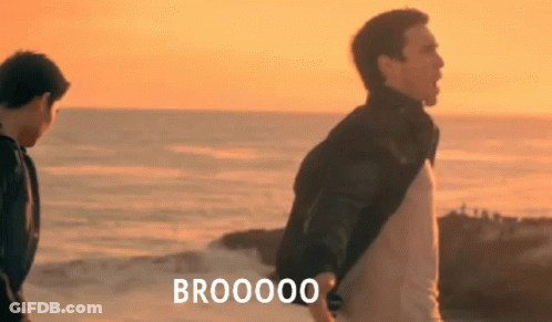 Two Men Are Standing On A Beach With The Words Brooooo Written On The Bottom GIF