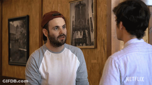 Two Men Talking In Room With Netflix Logo GIF
