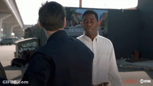 Men Talking In Front Of Senegal Billboard GIF