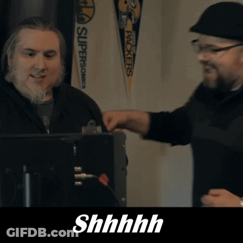 Two Men Are Talking In Front Of A Sign That Says " Packers " GIF