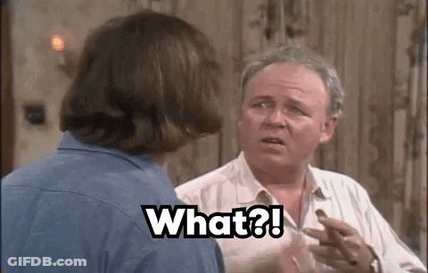 Two Men Talking, One Holding Chocolate GIF