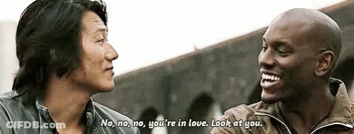 Two Men Are Talking To Each Other And One Of Them Is Laughing . GIF
