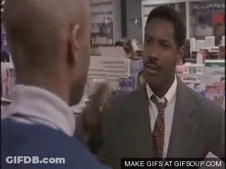 Two Men Are Talking To Each Other In A Store . GIF