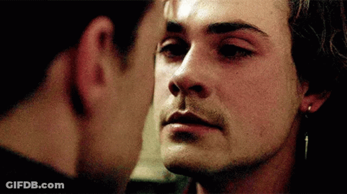 Two Men Are Touching Each Other 'S Faces In A Close Up Of Their Faces GIF