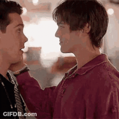Two Men Are Touching Each Other 'S Faces . GIF