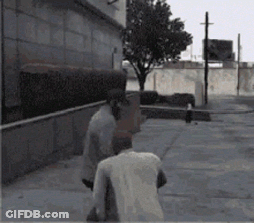Two Men Are Walking Down A Sidewalk In Front Of A Building And A Tree GIF