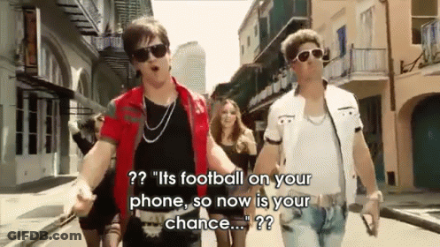 Two Men Are Walking Down A Street And One Of Them Is Saying " It 'S Football On Your Phone So Now Is Your Chance ... " GIF