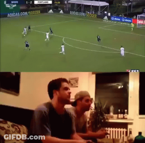 Two Men Are Watching A Soccer Game On A Tv Screen GIF