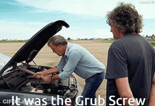 Two Men Are Working On A Car With The Words It Was The Grub Screw Written Below Them GIF
