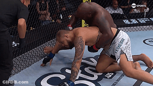 Two Men Are Wrestling In A Cage With The Words Tnt Sports On The Bottom Right GIF