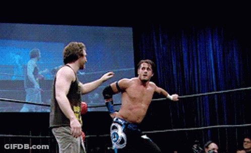 Two Men Are Wrestling In A Ring And One Has A Belt That Says ' A ' On It GIF