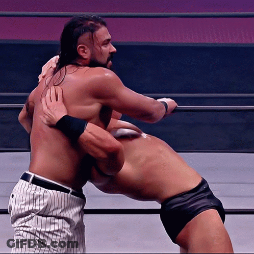 Two Men Are Wrestling In A Ring And One Is Wearing A Baseball Uniform GIF