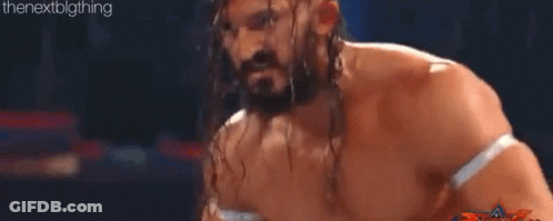 Two Men Are Wrestling In A Ring And One Of Them Is Jumping In The Air GIF