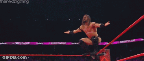 Two Men Are Wrestling In A Ring And One Of Them Is Laying On The Ground . GIF