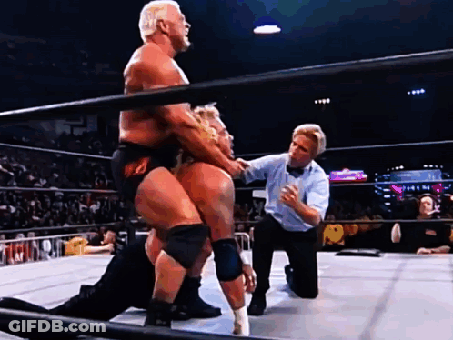 Two Men Are Wrestling In A Ring With A Referee GIF