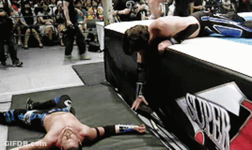 Two Men Are Wrestling In A Ring With A Sign That Says Super On It GIF