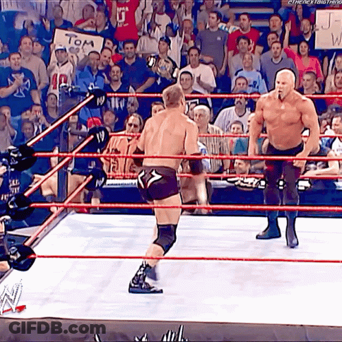 Two Men Are Wrestling In A Ring With A Sign That Says Tom GIF