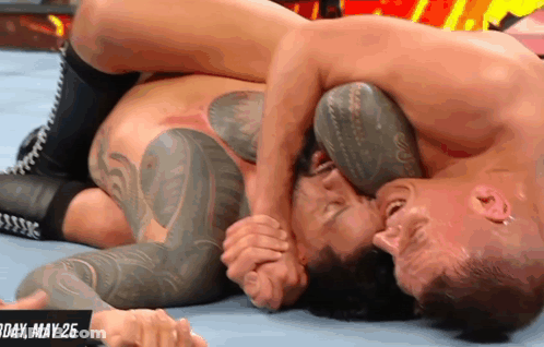 Two Men Are Wrestling In A Ring With The Date May 25 On The Bottom GIF