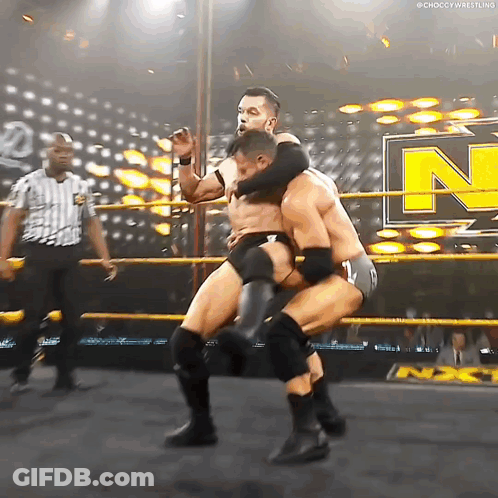 Two Men Are Wrestling In A Ring With The Letter N On The Side GIF