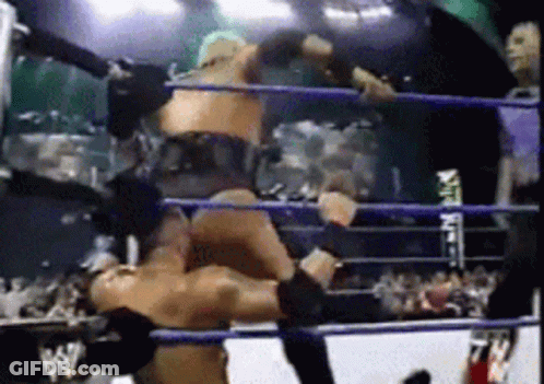 Two Men Are Wrestling In A Ring With The Letters Ww On The Ropes GIF