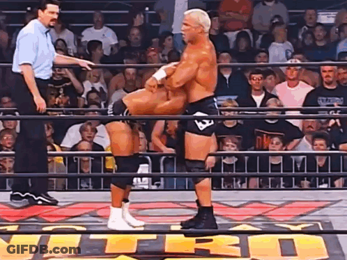 Two Men Are Wrestling In A Ring With The Word Nitro On The Floor GIF
