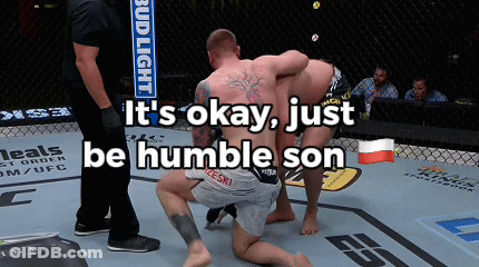 Two Men Are Wrestling In A Ring With The Words " It 'S Okay Just Be Humble Son " GIF
