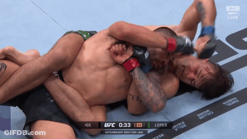 Two Men Are Wrestling In A Ufc Match With The Time Of 1:33 GIF