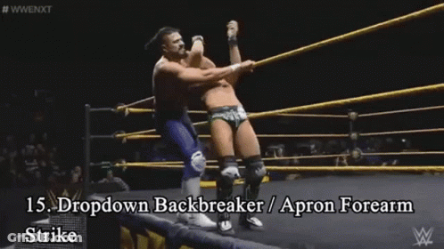 Two Men Are Wrestling In A Wrestling Ring And One Of Them Is Wearing An Apron GIF